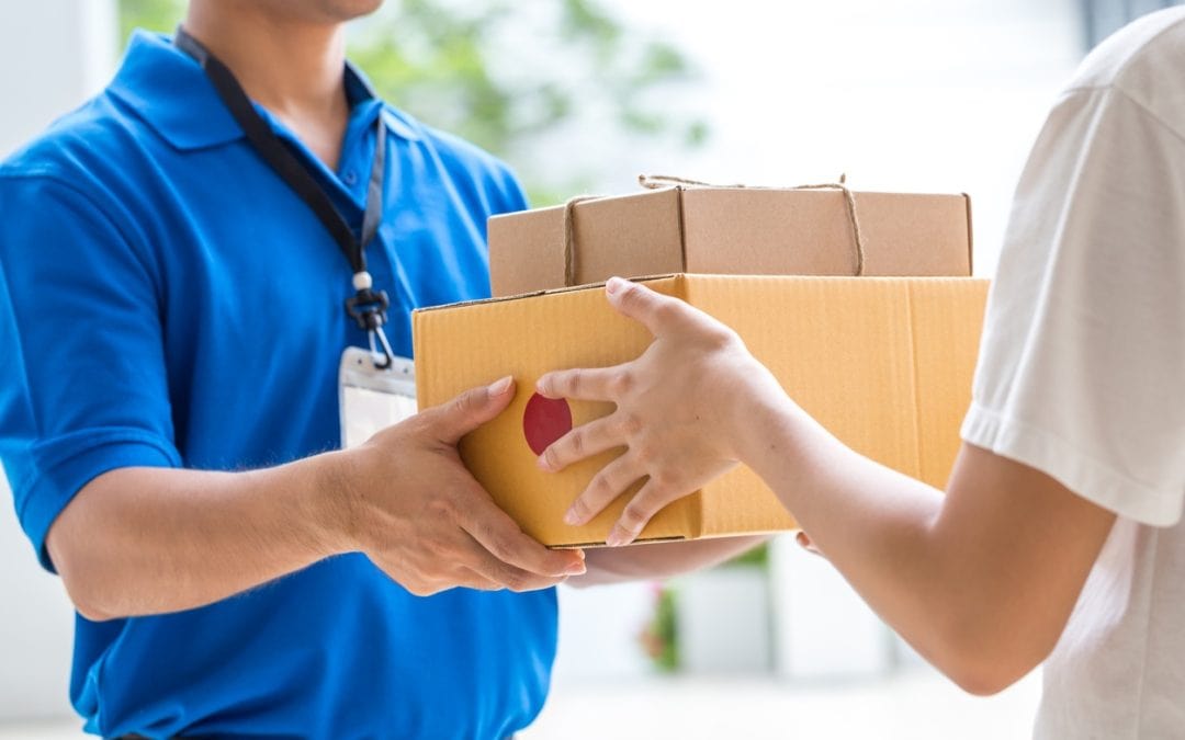 A person handing another person two packages.