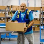 worker moving packages in a fulfillment center