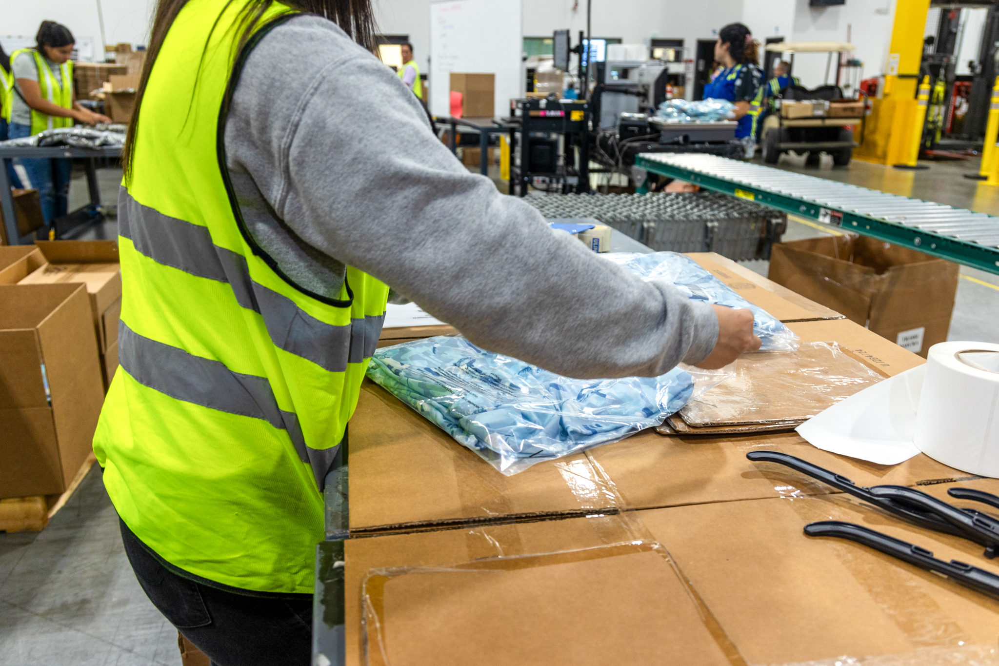 workers packaging items in a fulfillment center