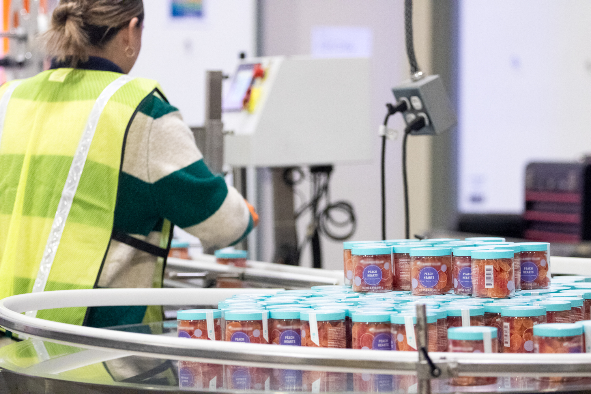 woman packing apparel at fulfillment center